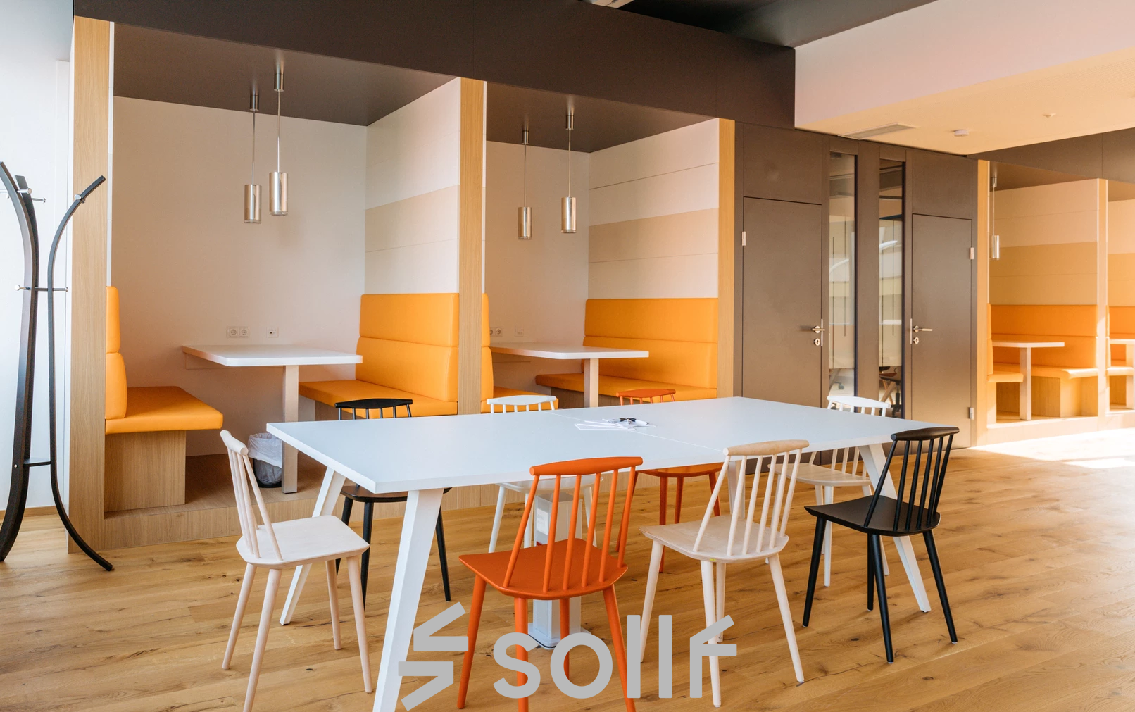 Modern gestalteter Büroraum zum Mieten auf der Waagner-Biro-Straße 47 in Graz mit Holzboden und farbenfrohen Möbeln.