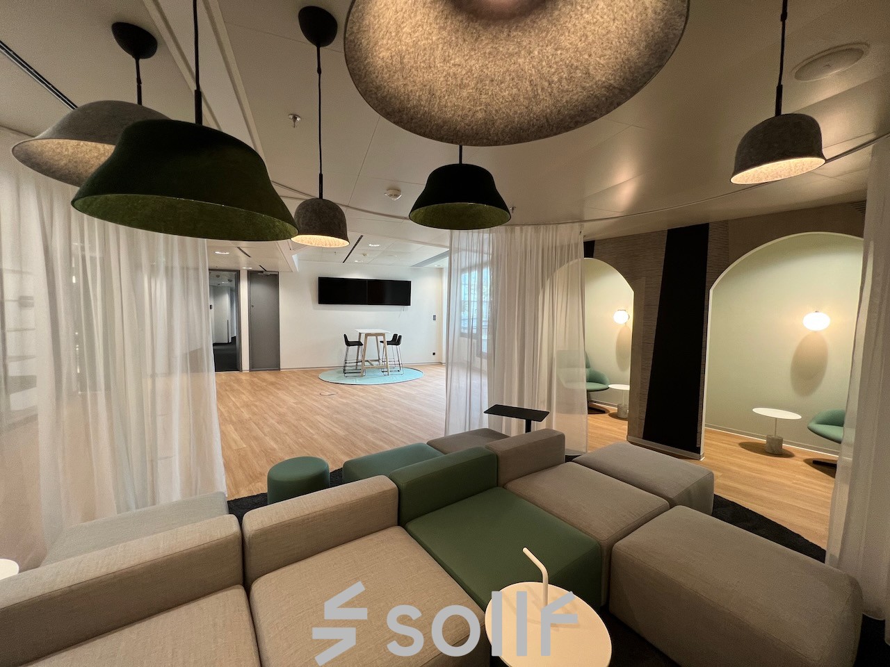 Modern office space rental at Am Euro Platz 2, 1120 Vienna Meidling, featuring a stylish lounge area with cozy seating and chic pendant lighting.