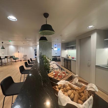 Modern office space rental at Am Euro Platz 2, 1120 Vienna Meidling, featuring a well-appointed common area with comfortable seating and a kitchenette.