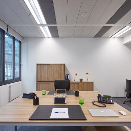 Modern office space rental at Am Euro Platz 2, 1120 Vienna Meidling with a well-equipped desk, comfortable seating, and ample natural light.